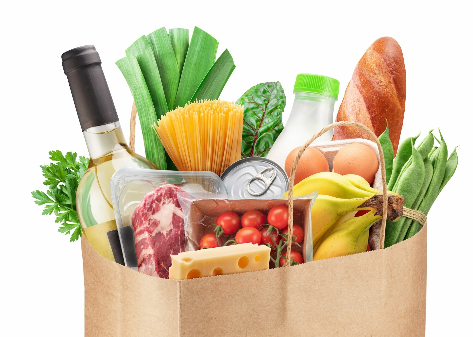 Reusable paper shopping bag with fresh organic vegetables, fruits and other grocery products on white background. File contains clipping path.